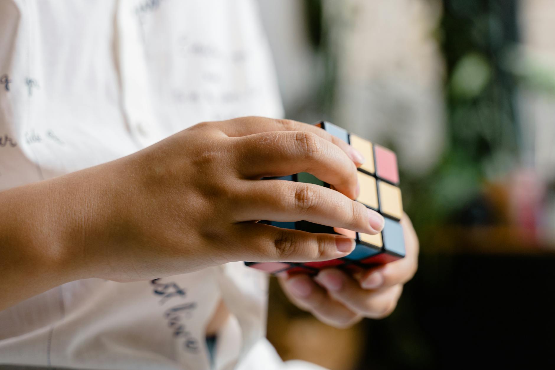 close up photo of a child solving a rubik s cube